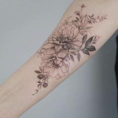 a black and white flower tattoo on the arm