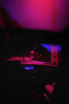 the interior of a car with red and blue lights