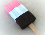 an ice cream popsicle with pink, white and black stripes