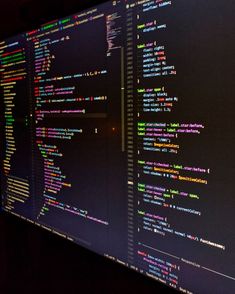 a computer screen with multiple lines of code on it's display wall in a dark room