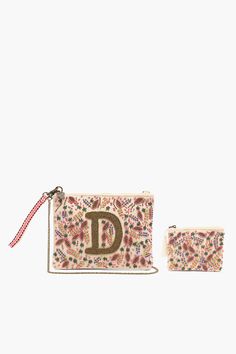 a pink purse and matching pouch with the letter d on it