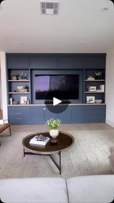 a living room filled with furniture and a flat screen tv mounted to the wall above it