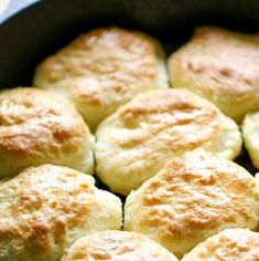 a pan filled with biscuits sitting on top of a stove