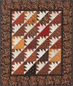 a quilt with many different colors and patterns on the front, along with an intricate border