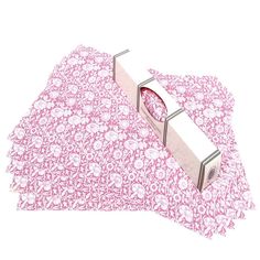 two pieces of pink fabric with silver handles on top of each other in front of a white background