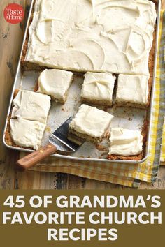 a pan filled with white frosted cake on top of a wooden table