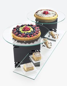 three desserts sitting on top of glass plates with different types of toppings in them