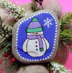 a painted rock with a snowman on it