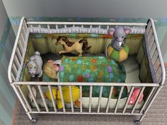 a baby crib with stuffed animals in it