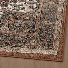 a brown and black area rug on top of a wooden floor