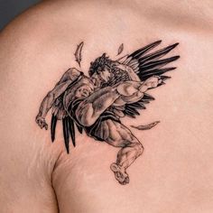 a man with an angel tattoo on his chest