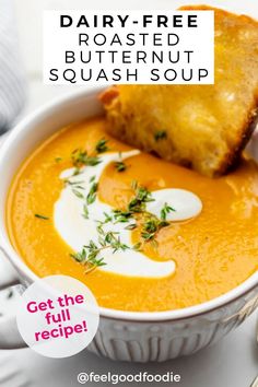 dairy - free roasted butternut squash soup in a white bowl with a piece of bread on the side