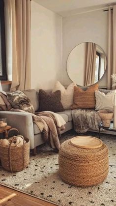 a living room filled with lots of furniture next to a large round mirror on the wall