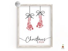 a christmas card with two handprints hanging from the strings, in front of a white background