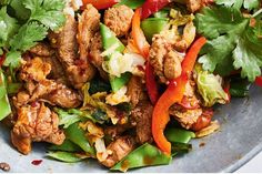 a close up of a plate of food with meat and veggies