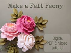 three paper flowers are placed on the wall to make a felt peony bouquet for someone's desk