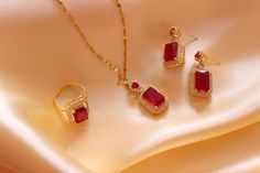 Introducing our exquisite Luxury Red Zircon Jewelry Set, a dazzling collection of meticulously crafted pieces designed to add a touch of elegance and sophistication to your style. This set includes a stunning Gemstone Pendant, Sapphire Ring, Necklace, and Earrings, making it the perfect choice for brides, engagements, or any special occasion. Features: 1. Red Zircon Gemstone Pendant: A brilliant red zircon gemstone is the focal point of this exquisite pendant. Crafted with precision and care, the pendant showcases the deep, rich hue of the red zircon. The pendant is elegantly set in a high-quality metal setting, adding to its allure. 2. Red Zircon Sapphire Ring: This dazzling ring features a radiant red zircon gemstone, accented by shimmering sapphire stones. The unique design and meticulo Dazzling Ruby Jewelry For Gifts, Ruby Round-shaped Jewelry Sets For Anniversary, Red Ruby Jewelry Sets As Gift, Red Ruby Jewelry Sets For Gifts, Red Ruby Jewelry Gift For Her, Dazzling Red Jewelry For Gift, Dazzling Red Jewelry Gift, Ruby Jewelry Sets For Gifts, Round Ruby Jewelry Sets For Gifts