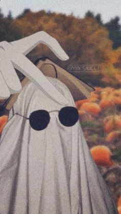 a painting of a ghost in a pumpkin patch with sunglasses on it's face