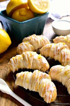 lemon meringue cookies with icing on a plate next to some lemons