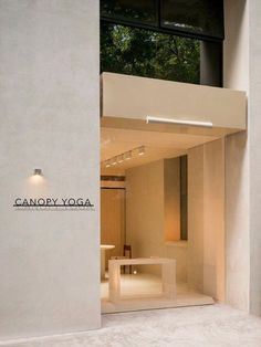 the entrance to a yoga studio with an open door and window above it that reads canopy yoga