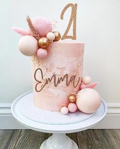 a pink and gold cake with the number twenty two on it