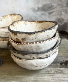 four white bowls stacked on top of each other