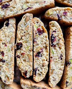 several pieces of bread with nuts and cranberry toppings