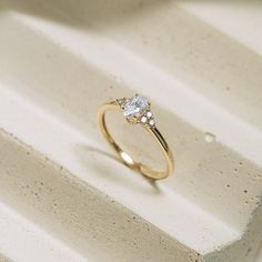 a diamond ring sitting on top of a white box