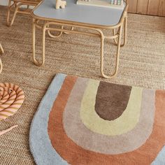 a living room area with rugs, chairs and tables on the carpeted floor