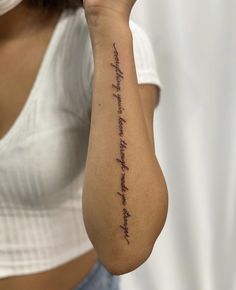 a woman with a tattoo on her arm that says, i am not afraid to see the