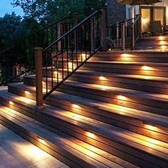 some lights are on the steps in front of a house