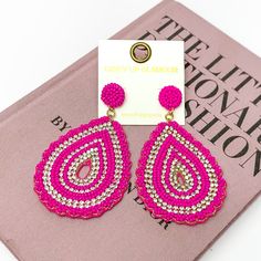 Sound Wave Beaded Drop Earrings with Clear Crystals in Fuchsia. Pictured on a white background with a book behind it. Trendy Pink Beaded Drop Earrings, Pink Teardrop Beaded Earrings For Party, Trendy Pink Beaded Earrings For Spring, Trendy Teardrop Beaded Earrings, Graphic Tee And Jeans, Beaded Teardrop Earrings, Sound Wave, Giddy Up Glamour, Beaded Drop Earrings