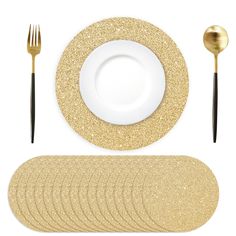 a table setting with gold glittered plates, silverware and black cutlery on white background