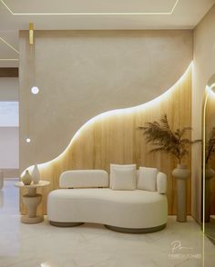 a modern living room with white furniture and wood paneling on the walls, along with potted plants