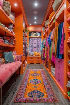 an orange walk in closet with lots of colorful rugs