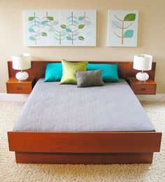 a bed with two lamps on either side of it