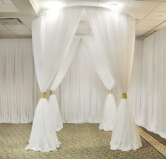 a room with white drapes and curtains