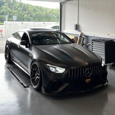 a black sports car parked in a garage