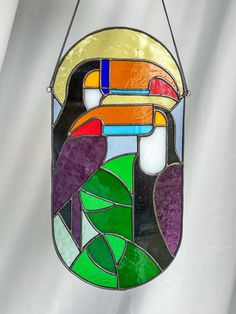 a stained glass window hanging from a chain