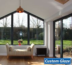 a living room filled with furniture and large windows