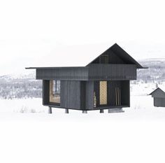 a small black house sitting on top of snow covered ground