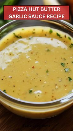 there is a bowl of soup on the table with carrots and celery