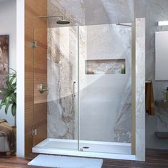 a walk in shower sitting next to a bathroom sink and bathtub with glass doors