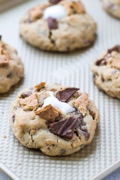 cookies with chocolate chips and marshmallows on a baking sheet