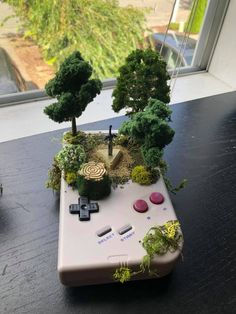 a video game controller with trees on it