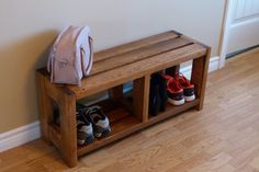 a wooden bench with several pairs of shoes on it and a handbag sitting next to it