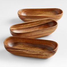 three wooden bowls sitting on top of each other