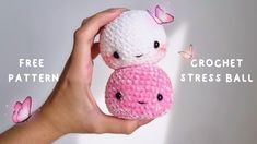 a hand holding two small crocheted balls with butterflies on them and the words free pattern below it