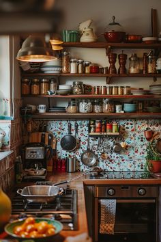 a kitchen with lots of pots and pans on the shelves above the stove top