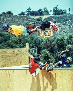 two skateboarders are doing tricks in the air